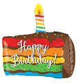 Celebrate with Betallic’s 28" Multi-Sided Rainbow Birthday Cake Balloon, featuring rainbow layers, chocolate frosting, a lit candle on top, and “Happy Birthday!” written in white script.
