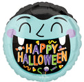 The 18" Haunted Manor Monster Foil Balloon from Anagram/MD features a round shape with a cartoon vampire face, fangs, blushing cheeks, "HAPPY HALLOWEEN" in colorful letters, and Halloween candies around the text.