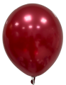 A 12" Decomex Luster Latex Balloon in red floats against a white background, its shiny metallic surface from Decomex reflecting light with bright highlights.