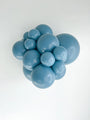 A cluster of shiny, smooth, blue TT-260's Tuftex Brand Twisting Animal Standard Latex Balloons in various sizes grouped together against a plain white background.