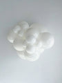 A cluster of smooth, glossy TT-260's White Tuftex Brand Twisting Animal Standard Latex Balloons from Tuftex in various sizes are grouped together against a white textured background, resembling abstract bubbles or a cloud.