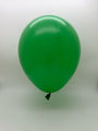 A 6'' Balloonia Brand Professional Line Latex Decolink Standard Green balloon from a 100-count bag floats against a plain white background with its tied end facing downward.