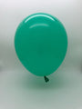 A single inflated Balloonia Professional Line mint green modelling latex balloon floats against a plain white background.
