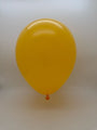 A single 12'' Balloonia Brand Professional Line Latex Balloon in standard yellow floats against a plain, light background.