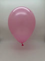 A single 23'' Balloonia Latex Balloons Professional Line Metallic Baby Pink balloon from Balloonia floats against a plain, light gray background.