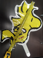 A 14.5" Anagram/MD Airfill Only Mini Shape Woodstock Snoopy Peanuts the Explorer foil balloon rests on a dark surface, with a tape measure showing its length is around 16 inches (40 cm). Sticks sold separately.