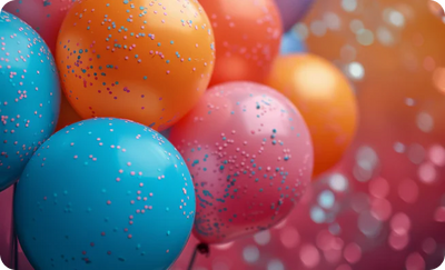 latex balloons in blue, pink, and orange with confetti dots