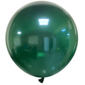 A 36″ Cattex Brand Crystal Green Latex Balloon floats indoors, its shiny surface reflecting room lights and surroundings.