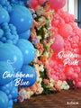 A colorful balloon display features large blue balloons on the left labeled Caribbean Blue and pink balloons on the right labeled 12″ Kalisan Latex Heart Balloons Standard Queen Pink (25 Per Bag) by Kalisan, with pastel flowers arranged between both sides.